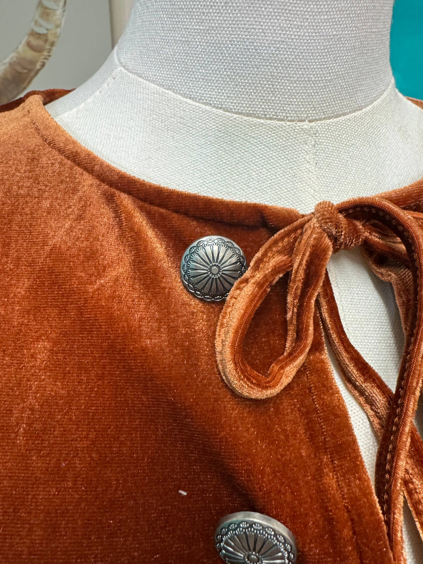 Rust velvet long sleeve peplum top, bow ties & conchos